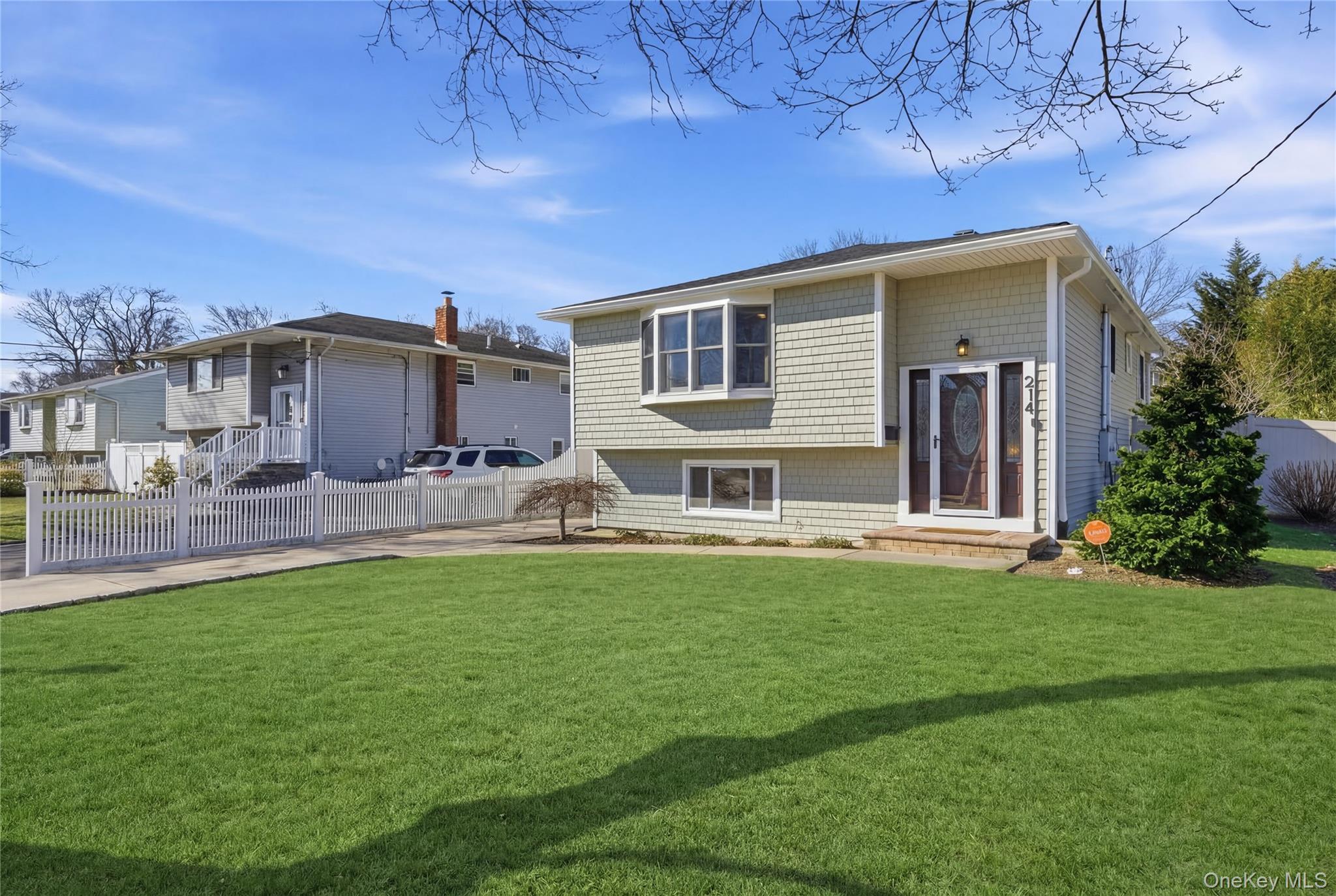 214 Ralph Avenue Babylon, NY 11702 - Photo 2 of 33 a backyard of a house with table and chairs