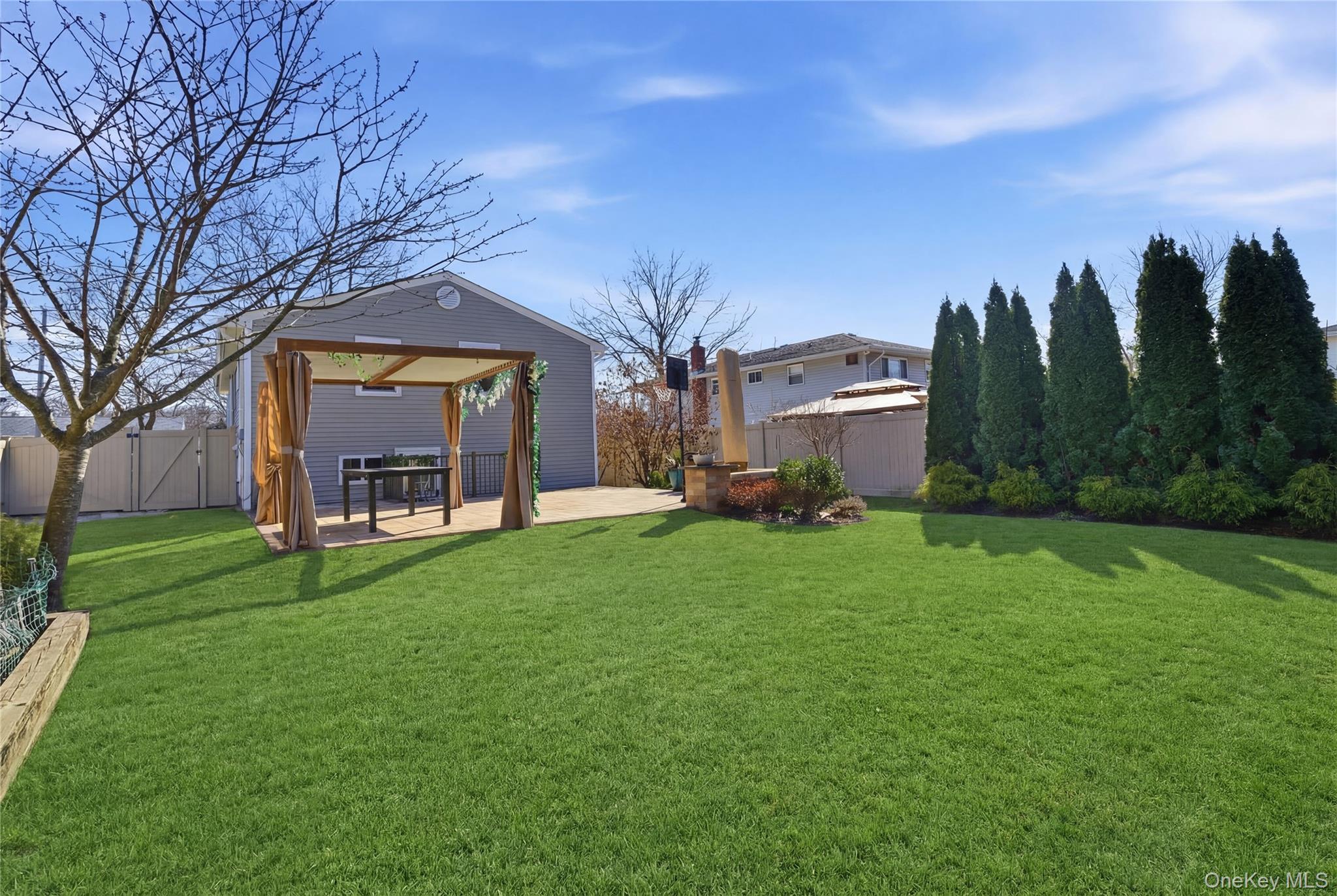 214 Ralph Avenue Babylon, NY 11702 - Photo 25 of 33 a view of a house with a backyard