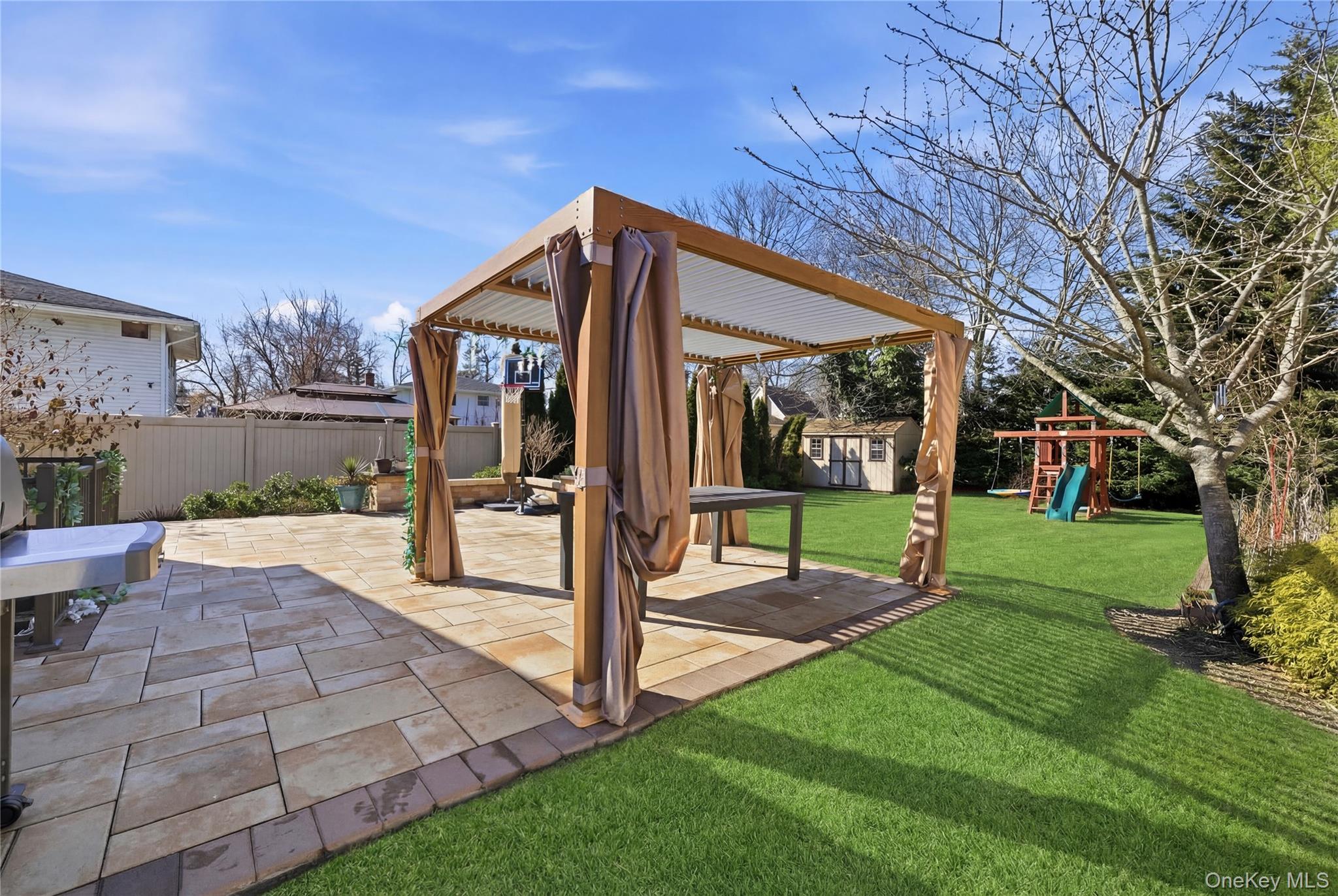 214 Ralph Avenue Babylon, NY 11702 - Photo 26 of 33 a view of a house with backyard and a patio
