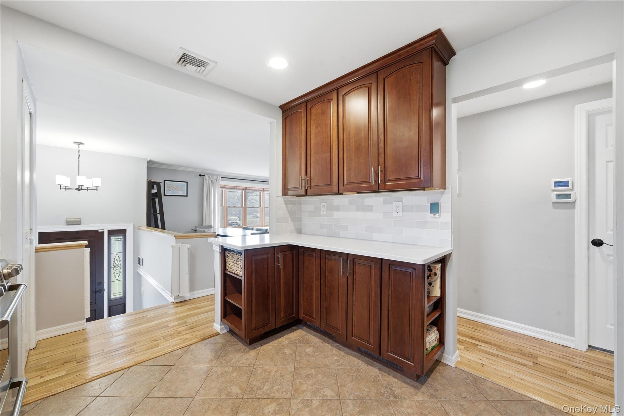 214 Ralph Avenue Babylon, NY 11702 - Photo 10 of 33 a kitchen with stainless steel appliances granite countertop a refrigerator and a stove top oven