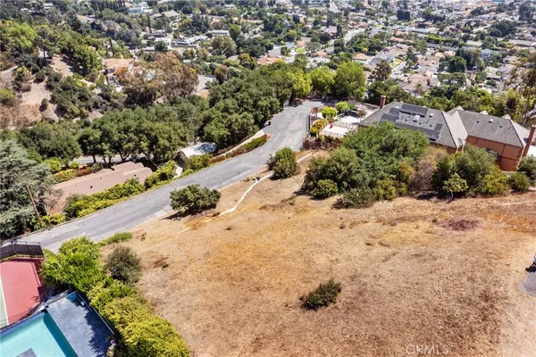 an aerial view of a house with swimming pool and lake view