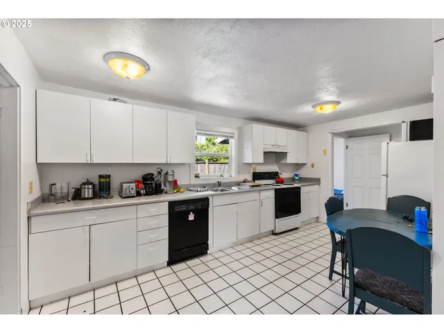 a kitchen with a sink cabinets and window