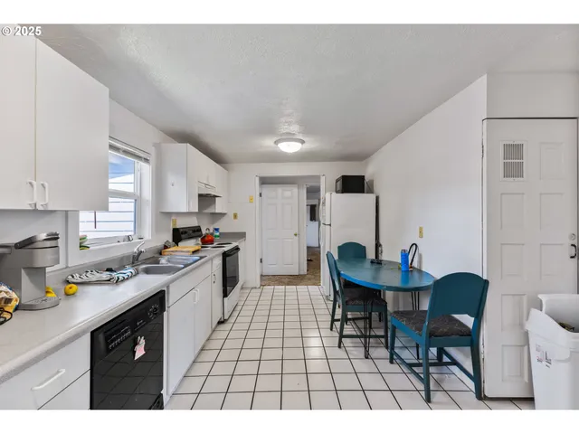 a kitchen with a sink cabinets and window