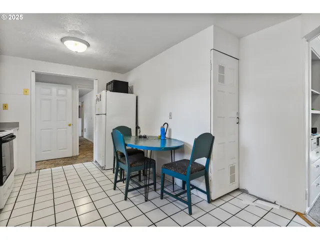 a living room with a table and a rug