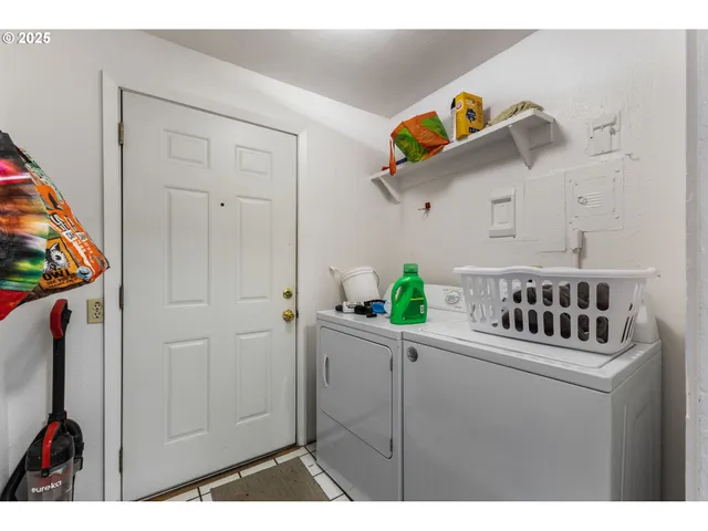 a kitchen with a white cabinets and wooden floor