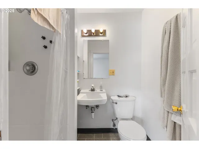 a bathroom with a sink toilet and mirror