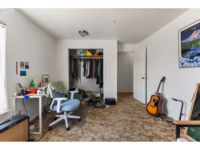 a living room with furniture a window and gym equipment
