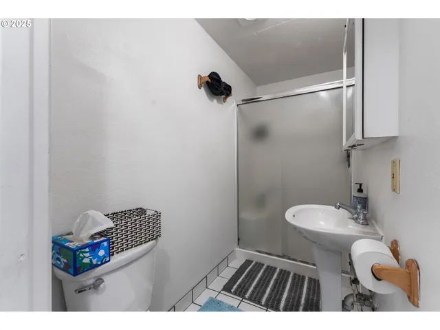 a bathroom with a toilet and a shower
