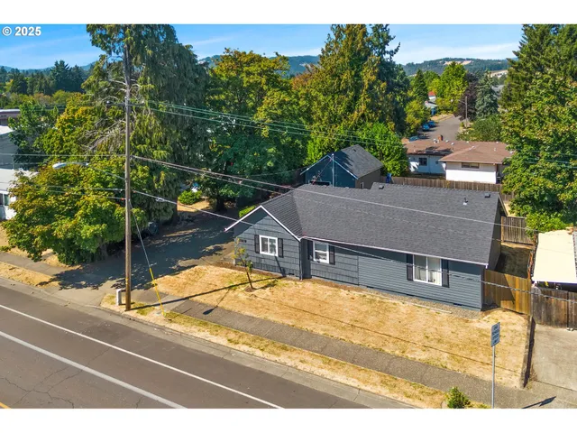 a view of a balcony with a floor to ceiling window and tree