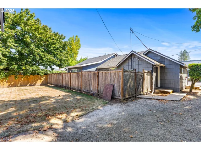 a view of a house with wooden fence
