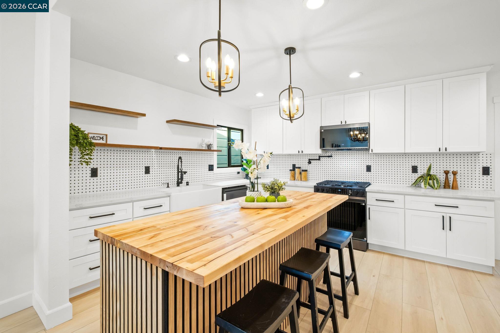 1920 Linden Street Oakland, CA 94607 - Photo 11 of 30 a kitchen with a table chairs and white cabinets