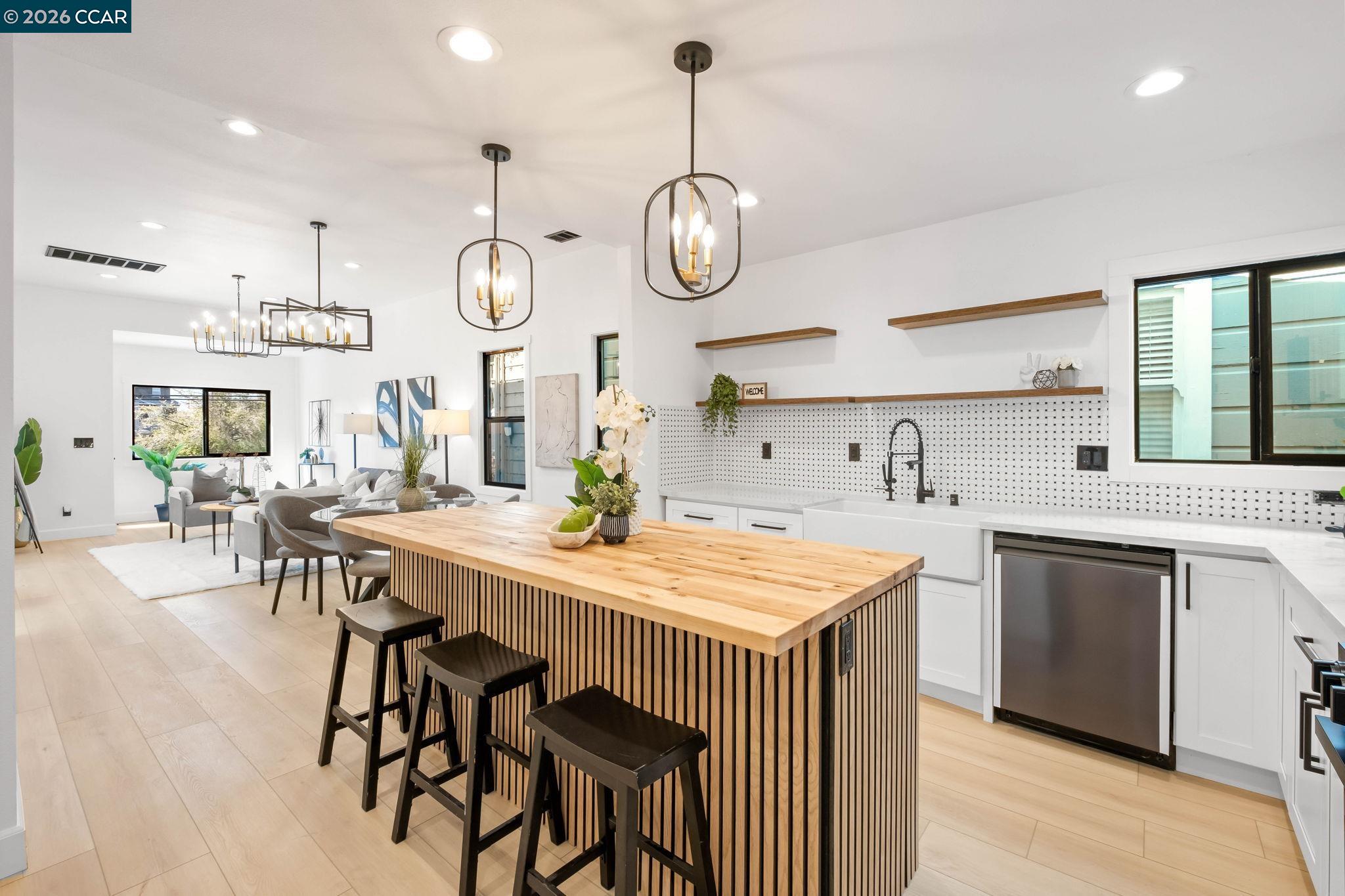 1920 Linden Street Oakland, CA 94607 - Photo 12 of 30 a kitchen with a table chairs and a clock on the wall