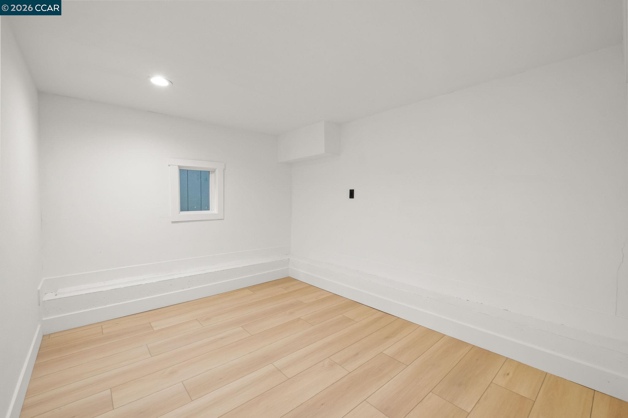 1920 Linden Street Oakland, CA 94607 - Photo 24 of 30 a view of an empty room with wooden floor and a window