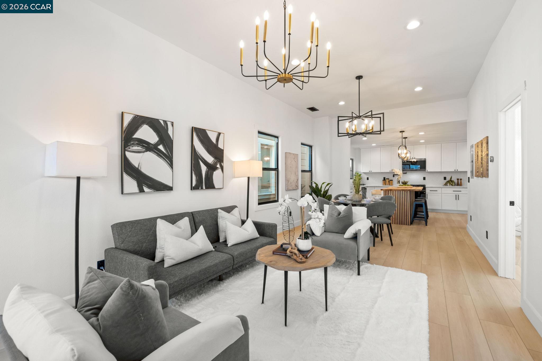 1920 Linden Street Oakland, CA 94607 - Photo 6 of 30 a living room with furniture kitchen view and a chandelier