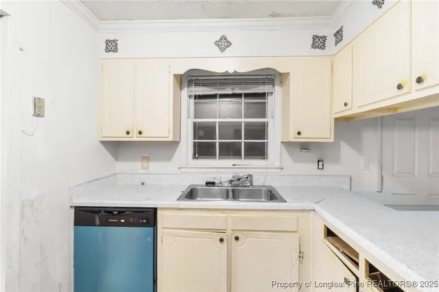 a kitchen with granite countertop white cabinets and window