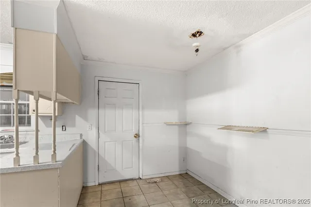 a view of walk in closet with white walls