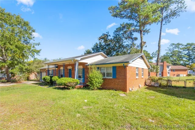 a front view of house with yard and green space