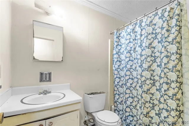 a view of a livingroom with a chandelier fan