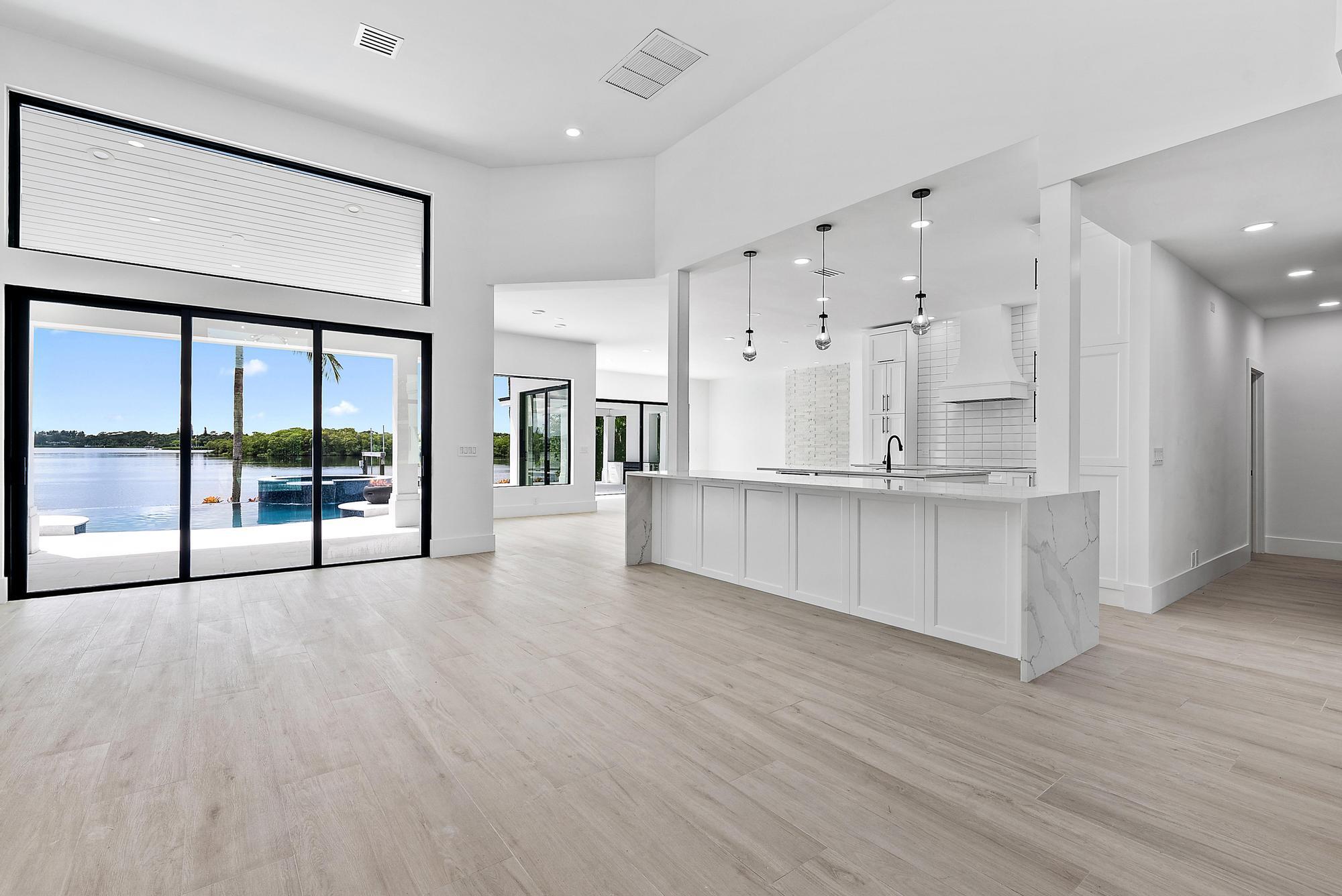 9460 Southeast Point Terrace Jupiter, FL 33469 - Photo 11 of 38 a view of an empty room with wooden floor and a large window