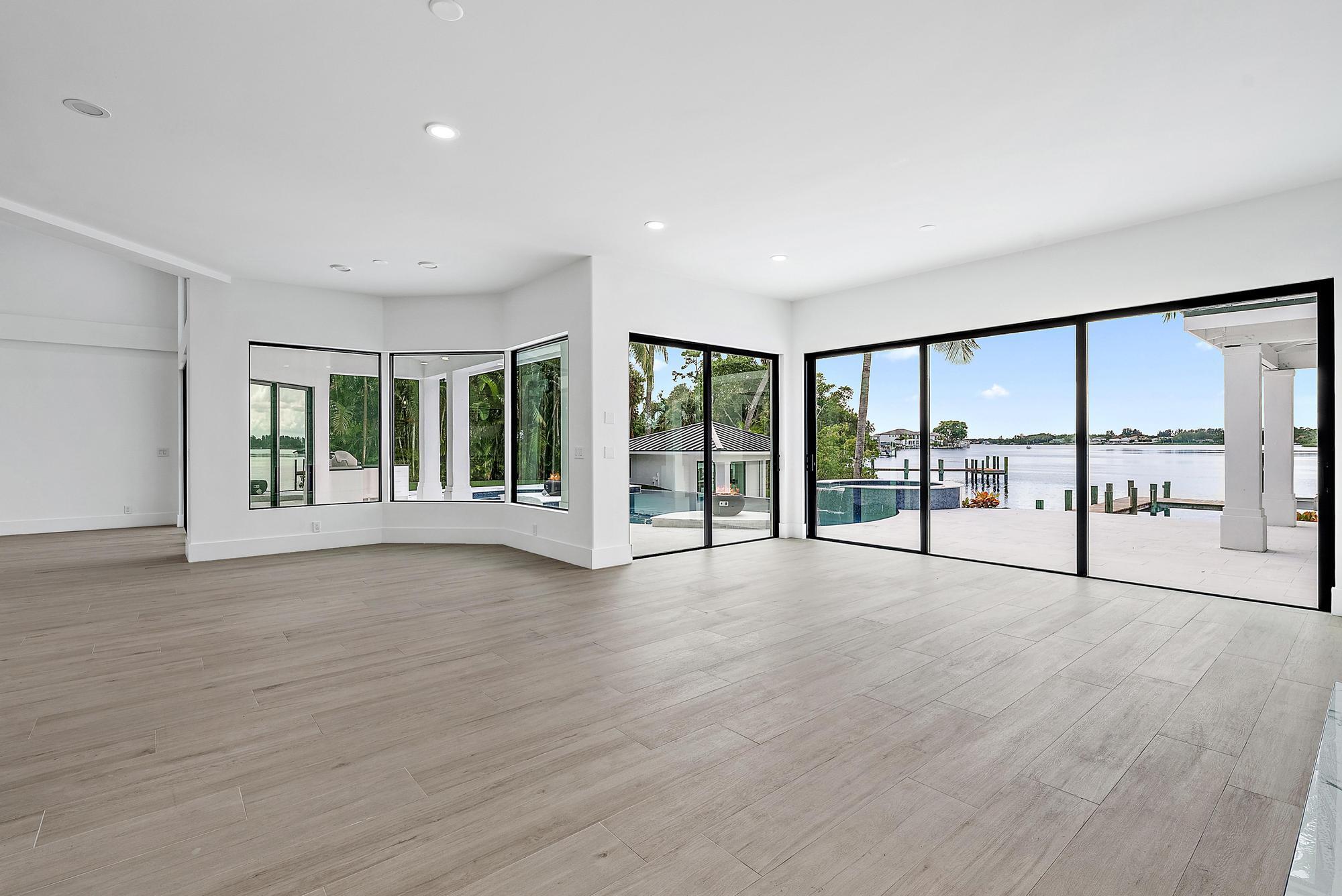 9460 Southeast Point Terrace Jupiter, FL 33469 - Photo 16 of 38 a view of an empty room with wooden floor and a window