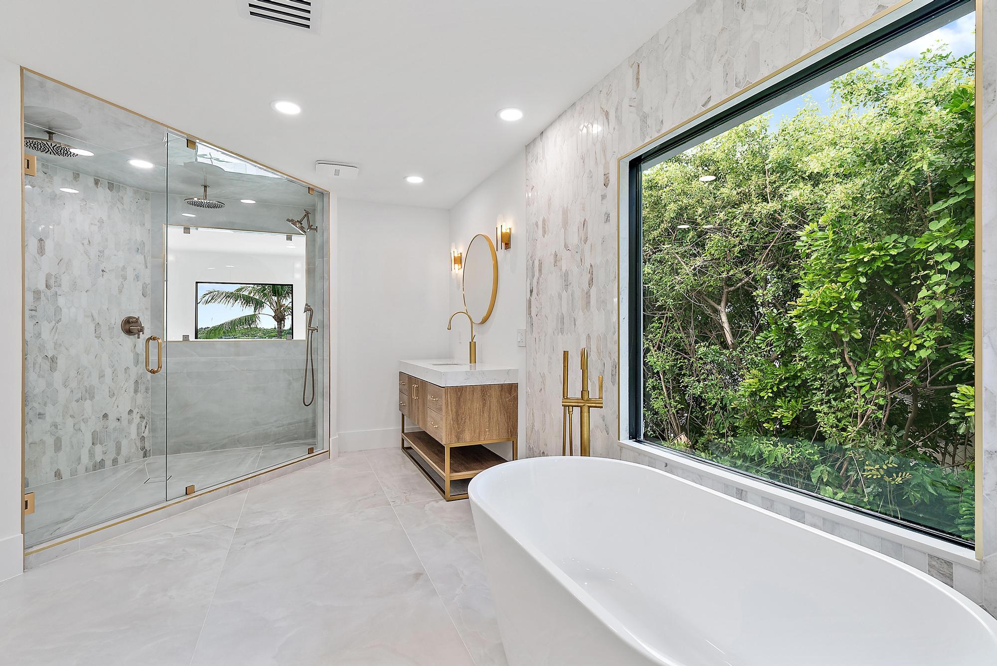 9460 Southeast Point Terrace Jupiter, FL 33469 - Photo 24 of 38 a view of a bathroom with a tub and window