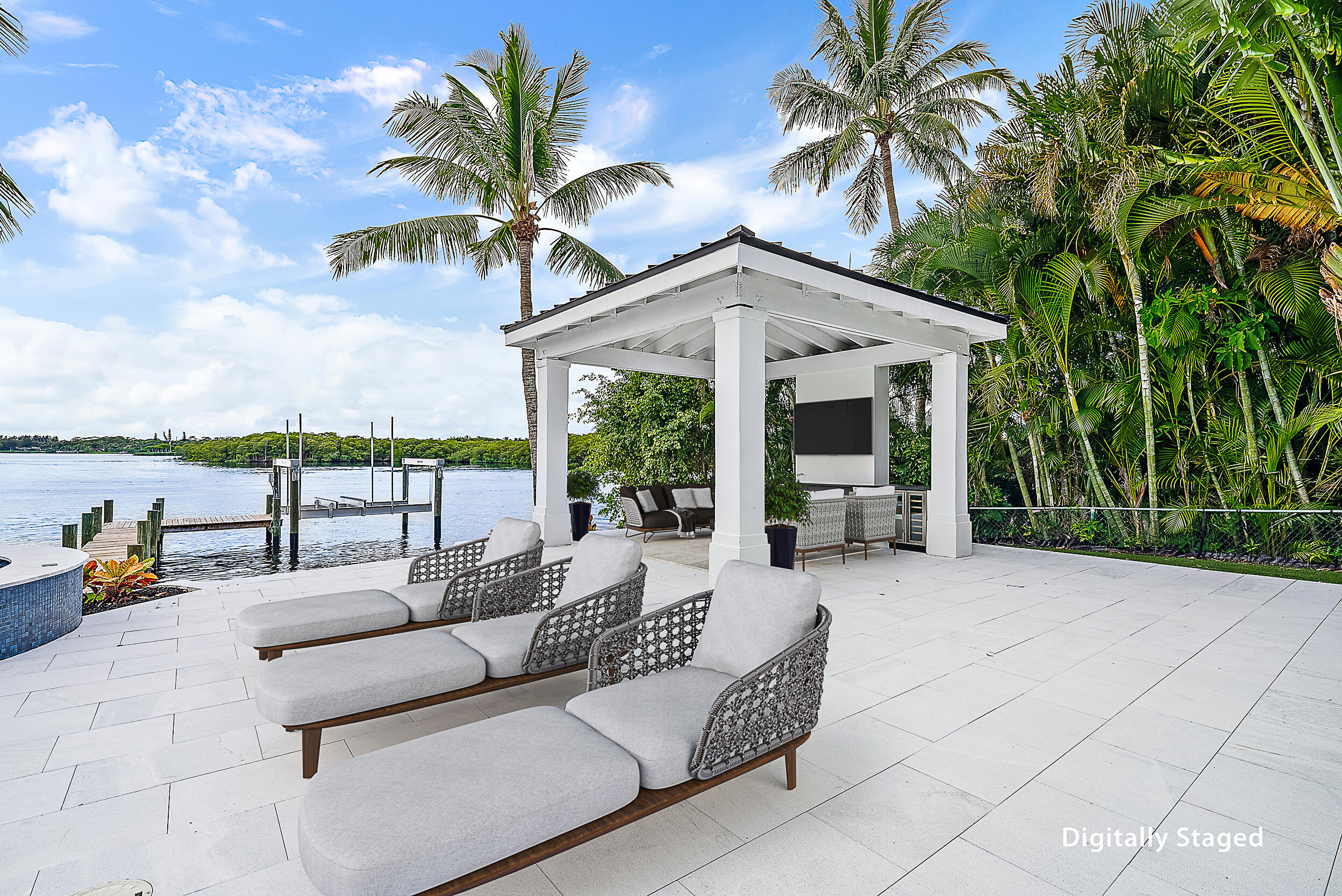 9460 Southeast Point Terrace Jupiter, FL 33469 - Photo 29 of 38 a view of a patio with couches and a table and chairs with wooden fence
