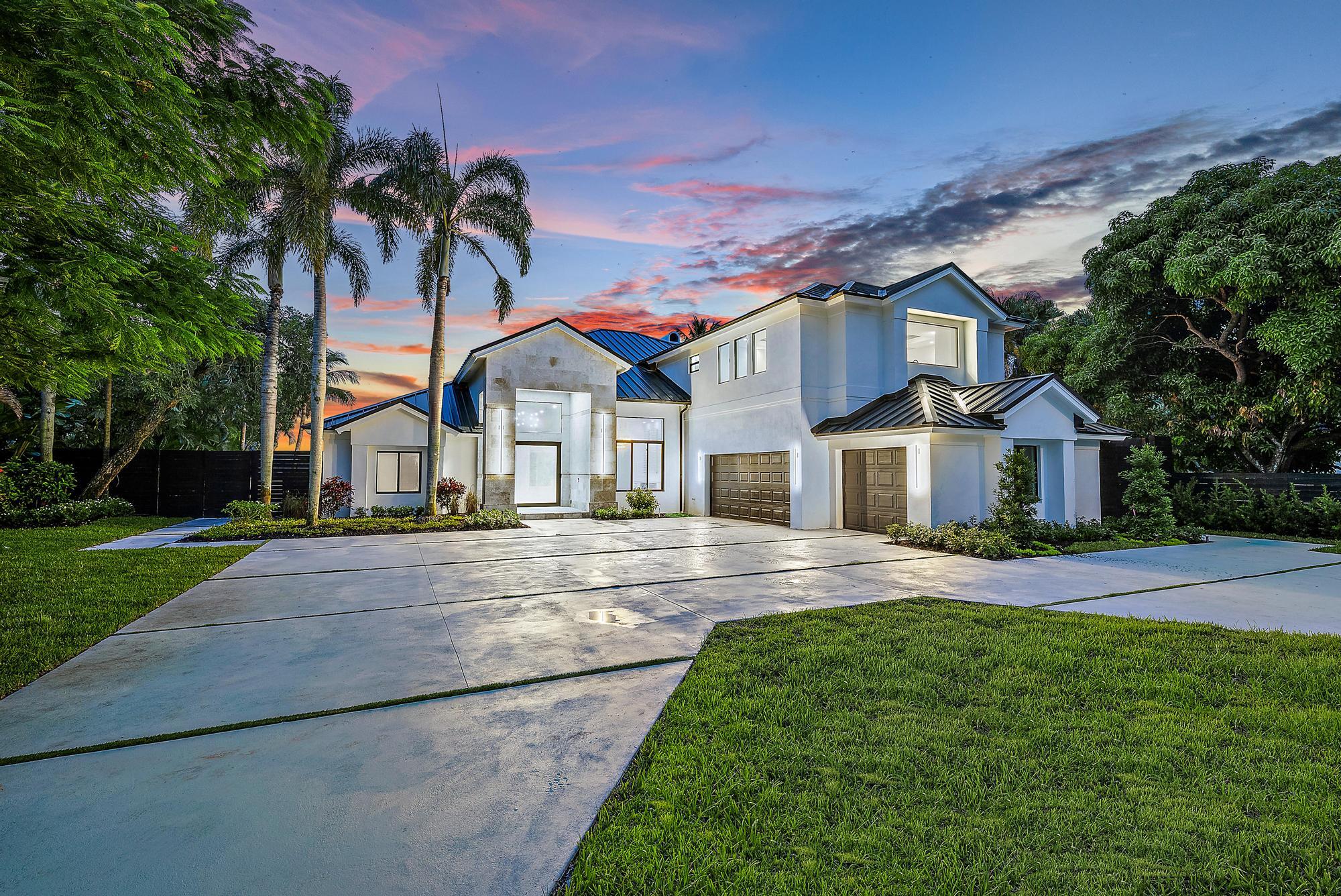 9460 Southeast Point Terrace Jupiter, FL 33469 - Photo 6 of 38 a front view of a house with a yard and potted plants