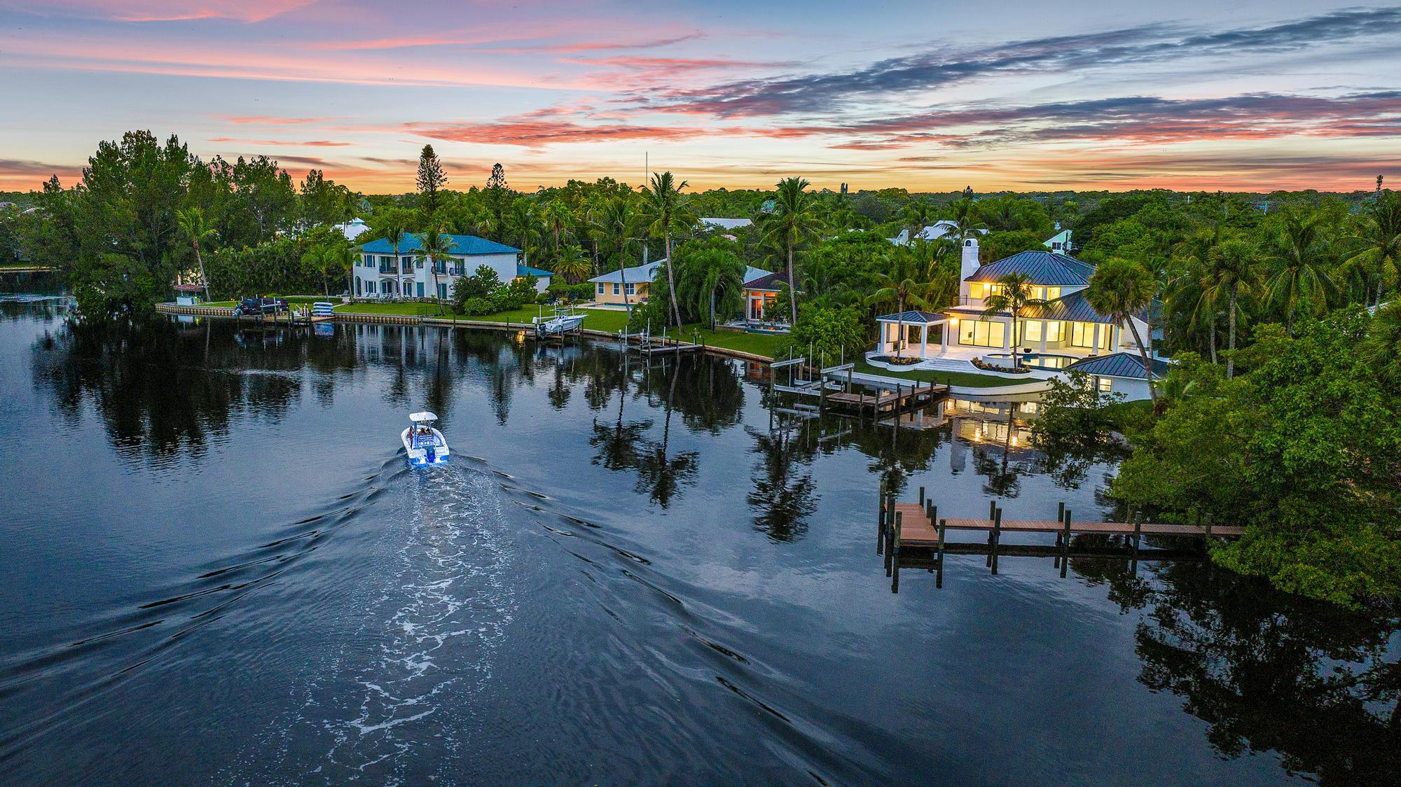 9460 Southeast Point Terrace Jupiter, FL 33469 - Photo 7 of 38 a view of a lake in front of residential houses with outdoor space