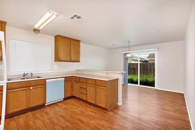 a view of a kitchen with sink and wooden floor