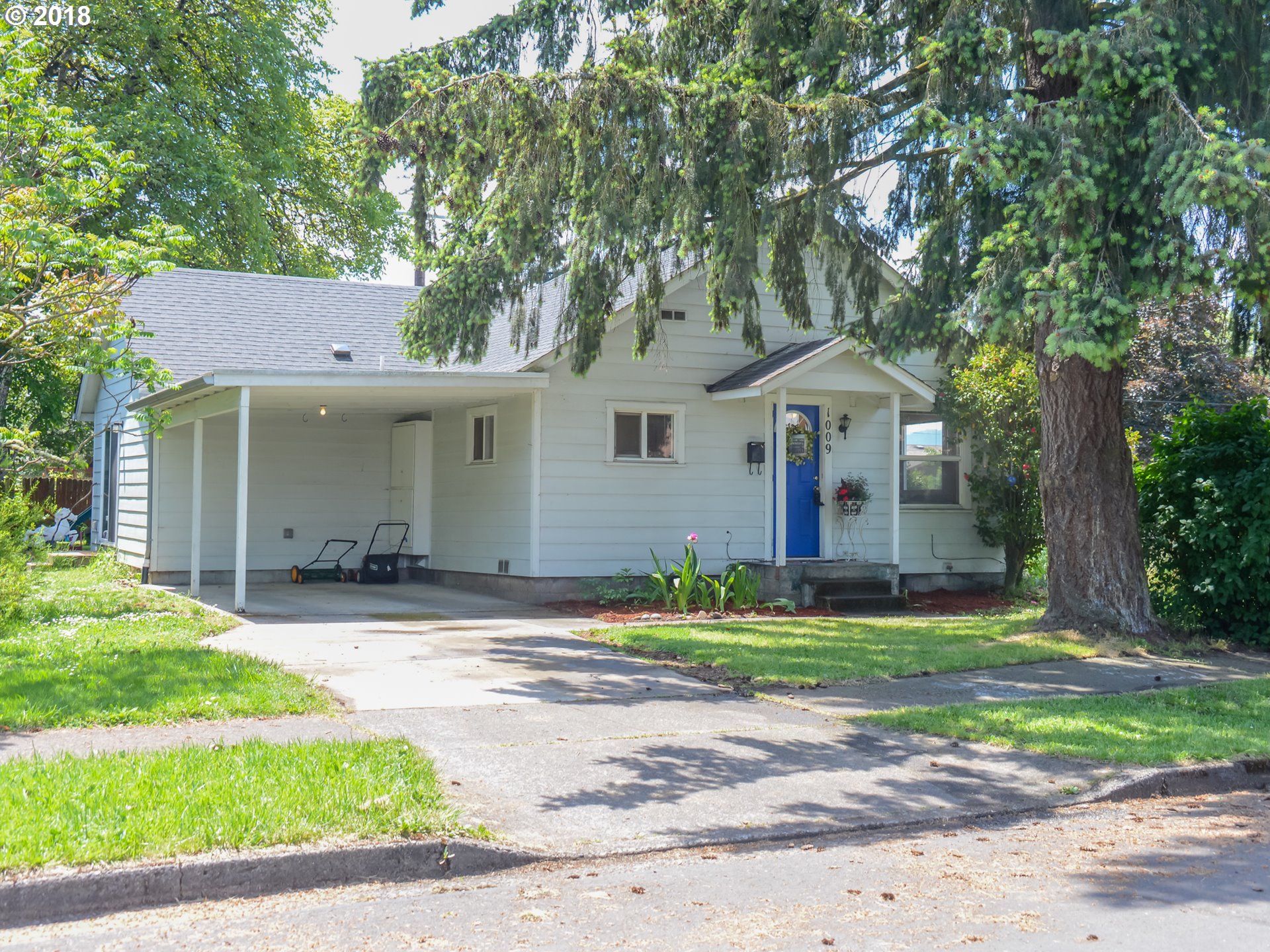 1009 L Street Springfield, OR 97477 - Photo 1 of 5 a front view of a house with a yard and garage