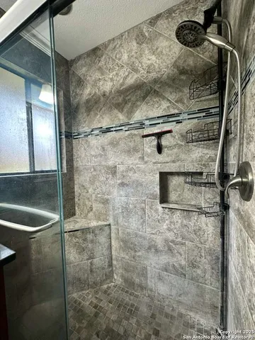 an empty room with wooden floor and chandelier