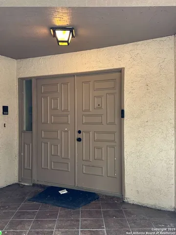 a living room with stainless steel appliances kitchen island a table and chairs