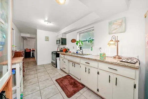 a kitchen with stainless steel appliances a stove microwave and cabinets