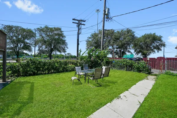 a view of a chair and table in the backyard