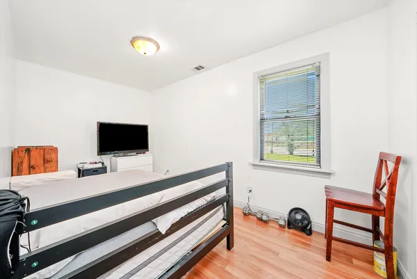 a room with a bed and a television