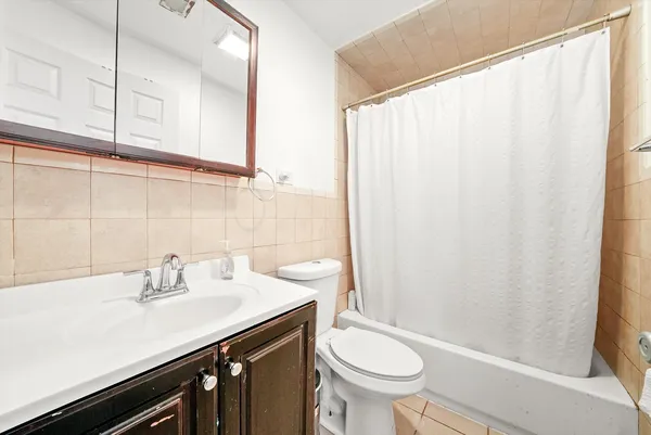 a bathroom with a sink a toilet and shower curtain