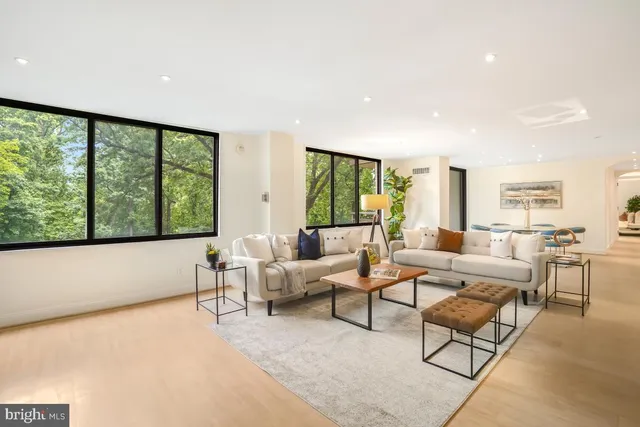 a living room with furniture and large windows