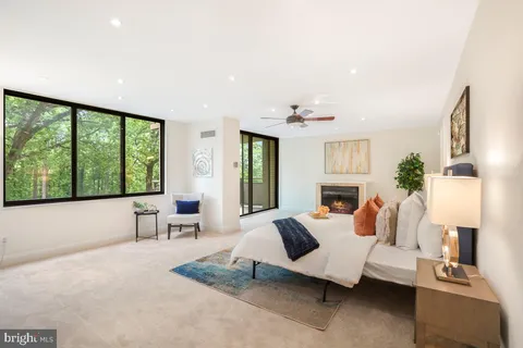 a living room with furniture and large windows
