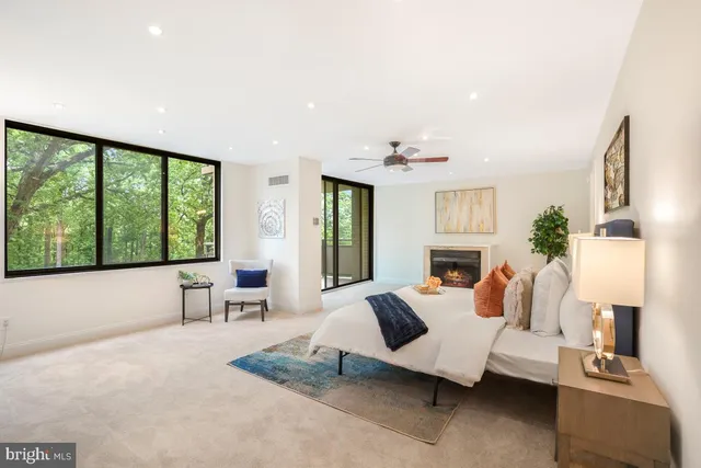 a living room with furniture and large windows