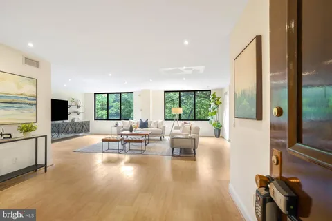 a living room with fireplace furniture and a large window
