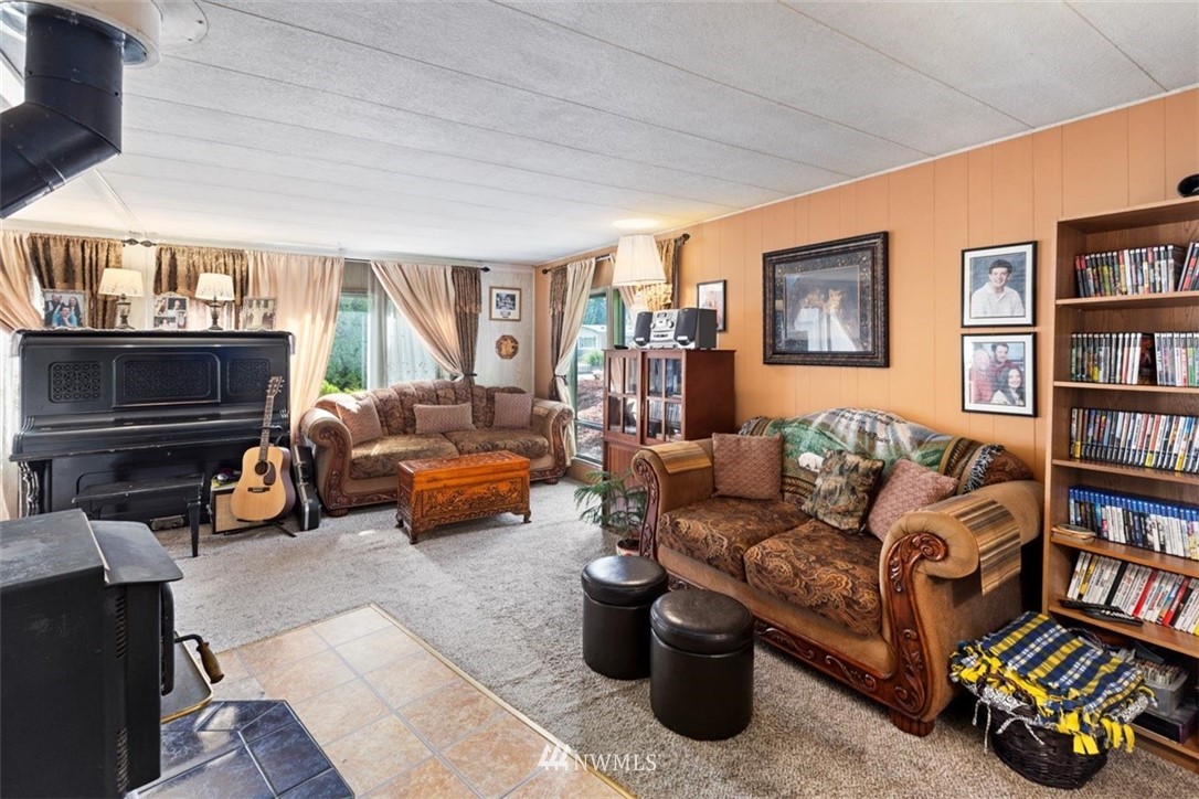 3329 206th Place Southeast Bothell, WA 98012 - Photo 4 of 29 a living room with furniture and a book shelf