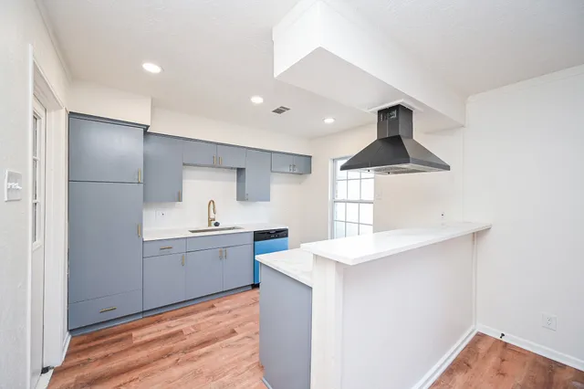 a kitchen with kitchen island a sink stainless steel appliances and counter space
