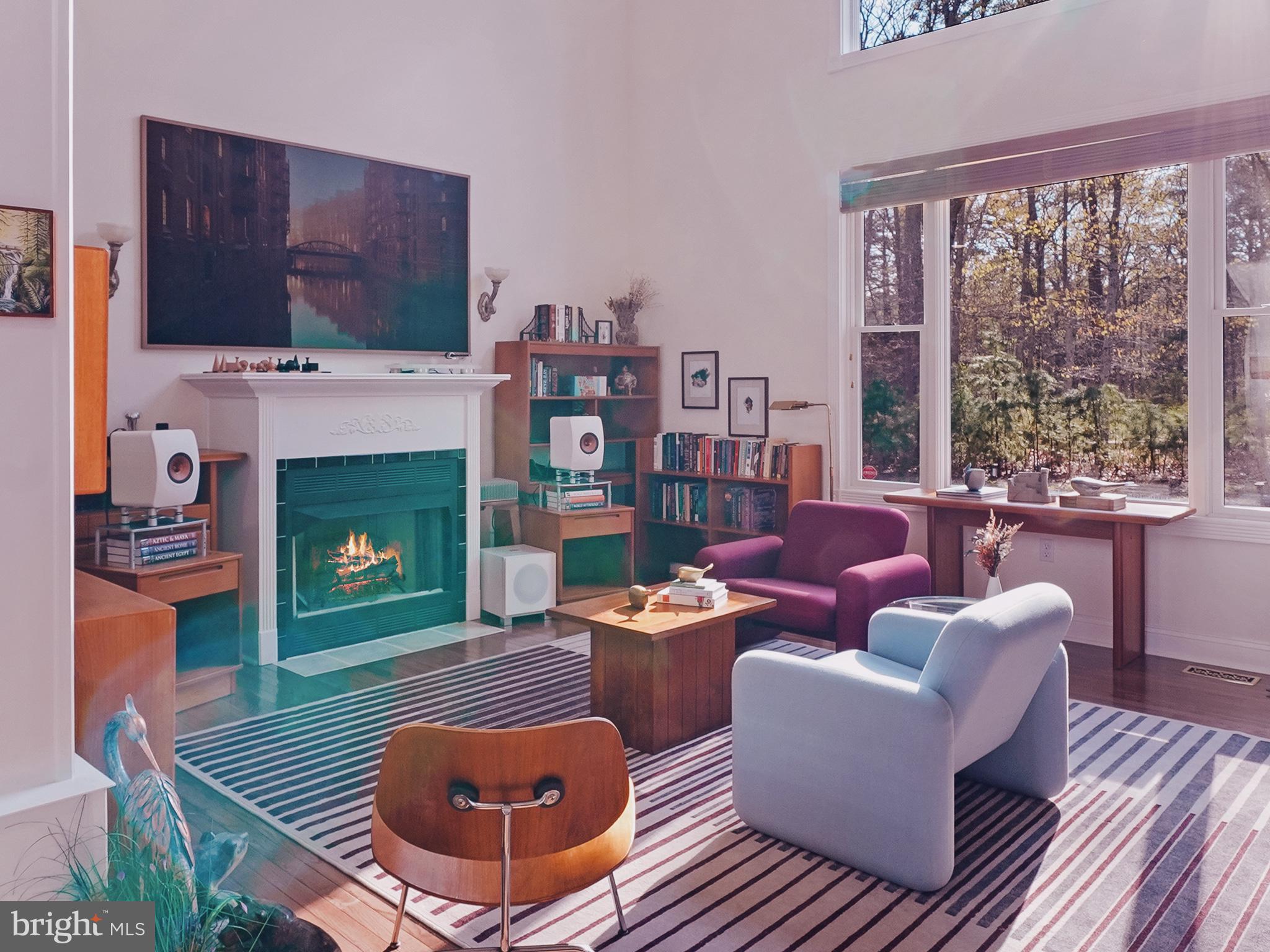 33 North New York Road Galloway Township, NJ 08205 - Photo 13 of 47 a living room with furniture a fireplace and a floor to ceiling window