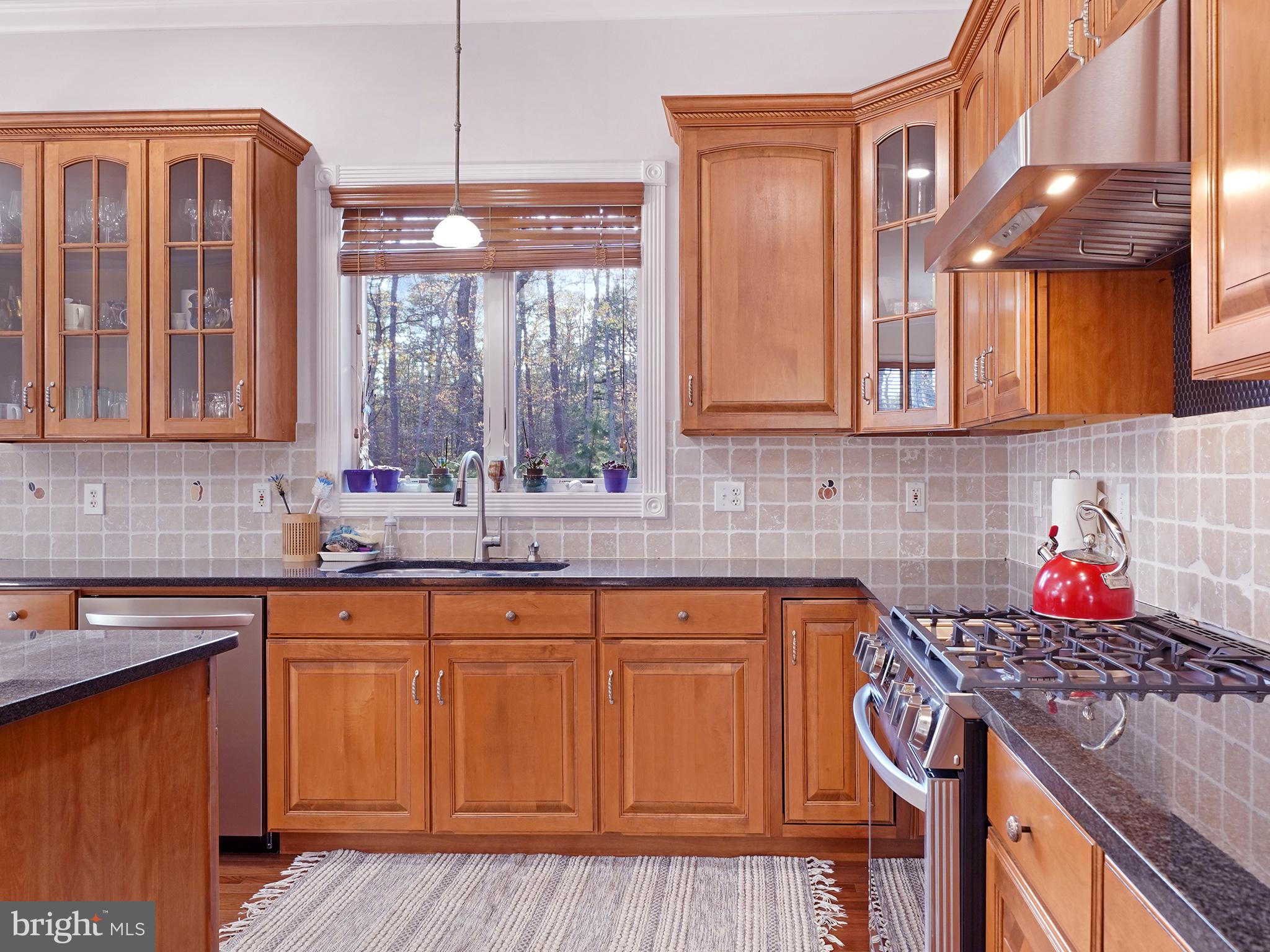 33 North New York Road Galloway Township, NJ 08205 - Photo 23 of 47 a kitchen with stainless steel appliances granite countertop a sink stove and cabinets