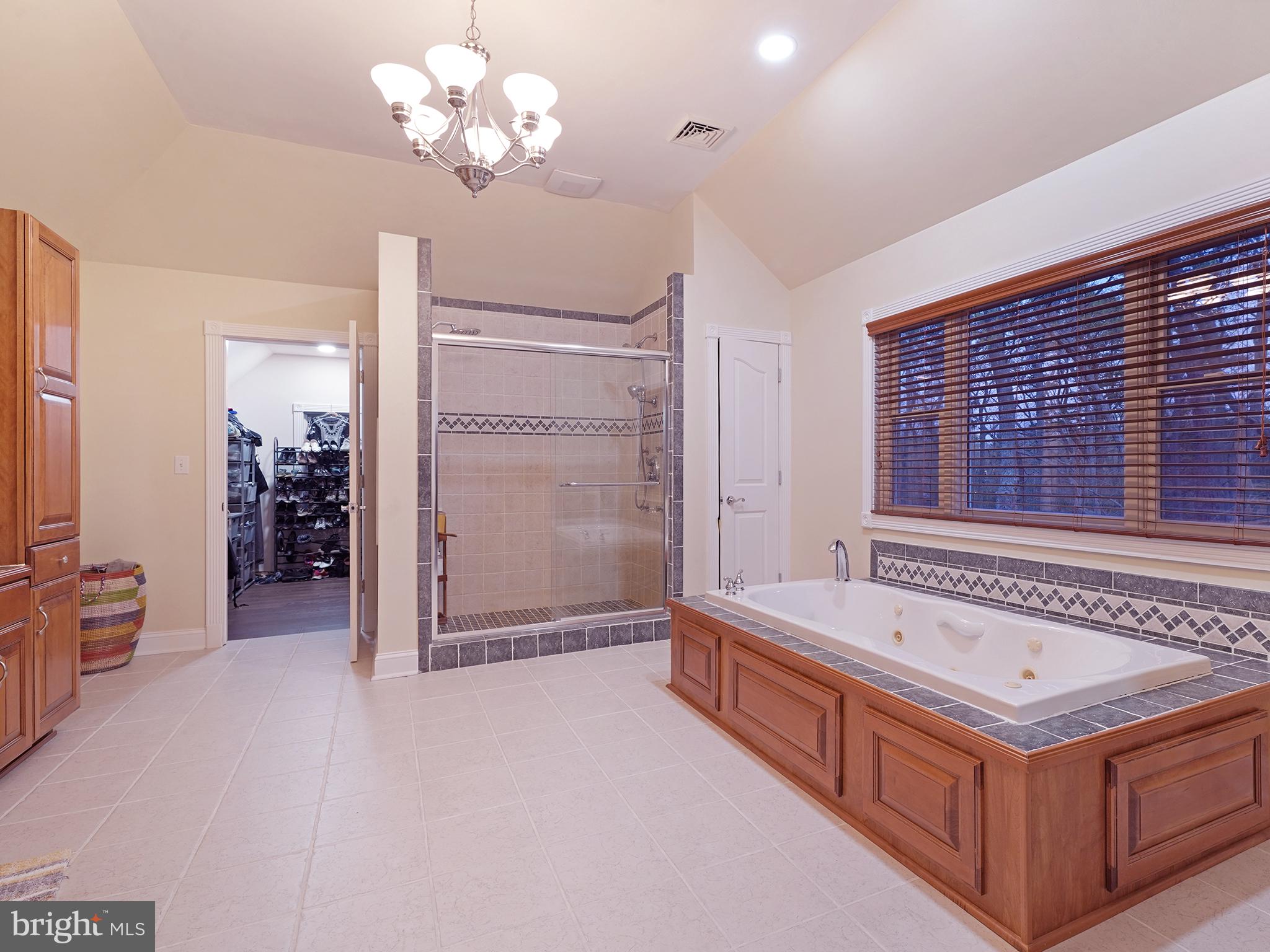 33 North New York Road Galloway Township, NJ 08205 - Photo 31 of 47 a spacious bathroom with a double vanity sink a large mirror and a bathtub