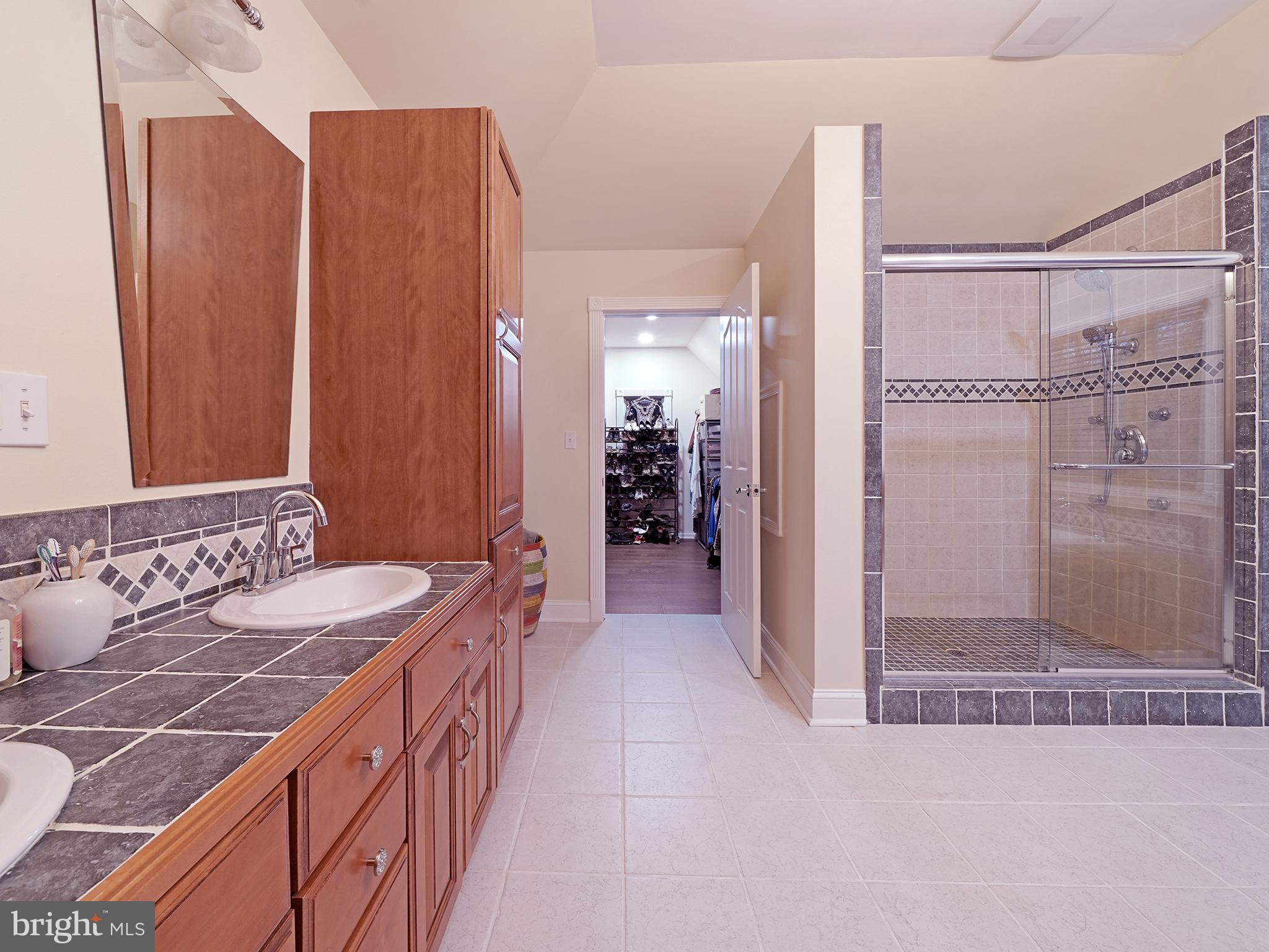 33 North New York Road Galloway Township, NJ 08205 - Photo 32 of 47 a bathroom with a double vanity sink and a mirror