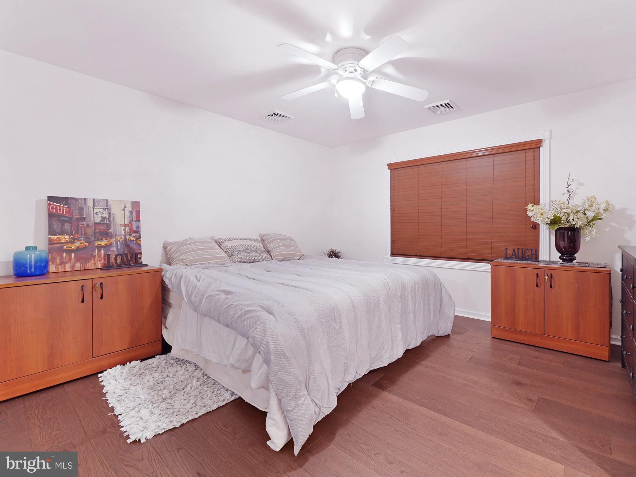 33 North New York Road Galloway Township, NJ 08205 - Photo 35 of 47 a bedroom with a large bed and a chandelier