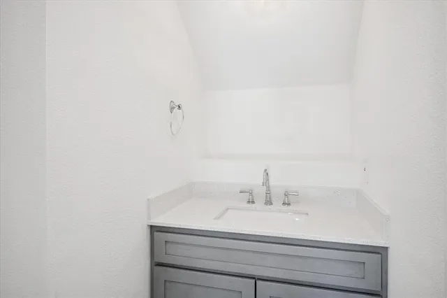 a bathroom with a sink and vanity