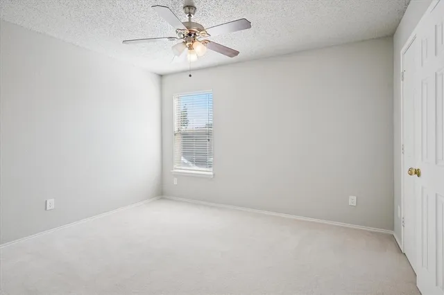 a view of room with a ceiling fan and window