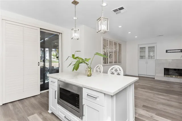 a kitchen with stainless steel appliances granite countertop a stove and a wooden floor
